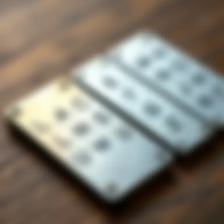 A close-up of metal plates used for securely storing cryptocurrency seed phrases. The plates have engraved slots for letters and numbers, resting on a wooden surface.