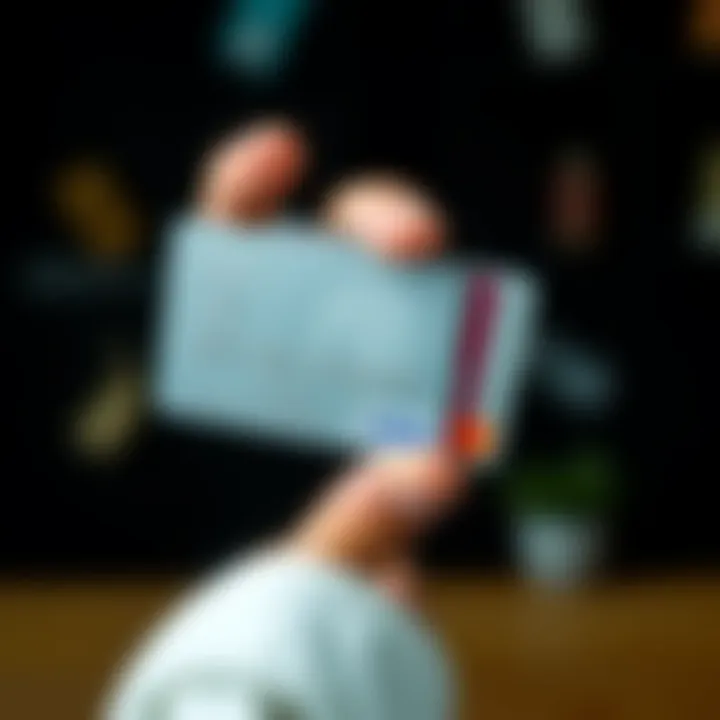 A hand holding a plastic credit card next to a metal credit card, showing comparison between the two types of cards