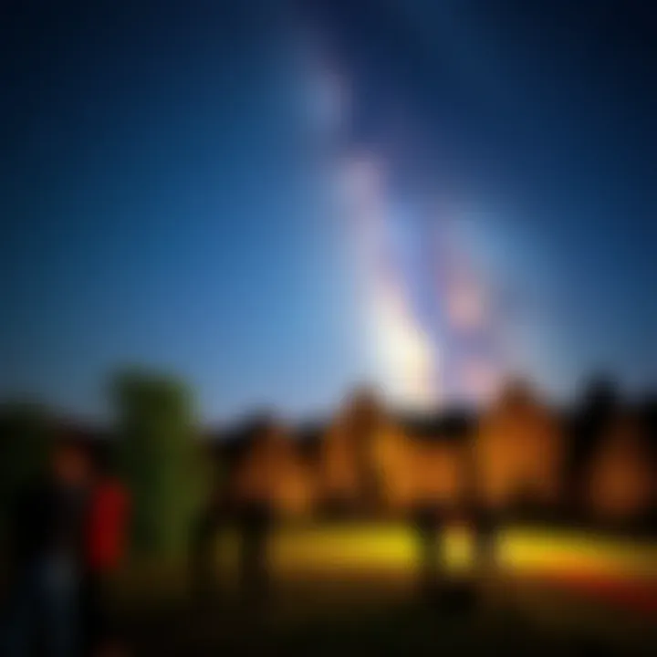 People stargazing at Kingsbury Park under a clear night sky filled with stars and the Milky Way